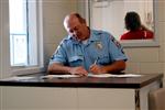 Picture of and ADC officer doing paperwork