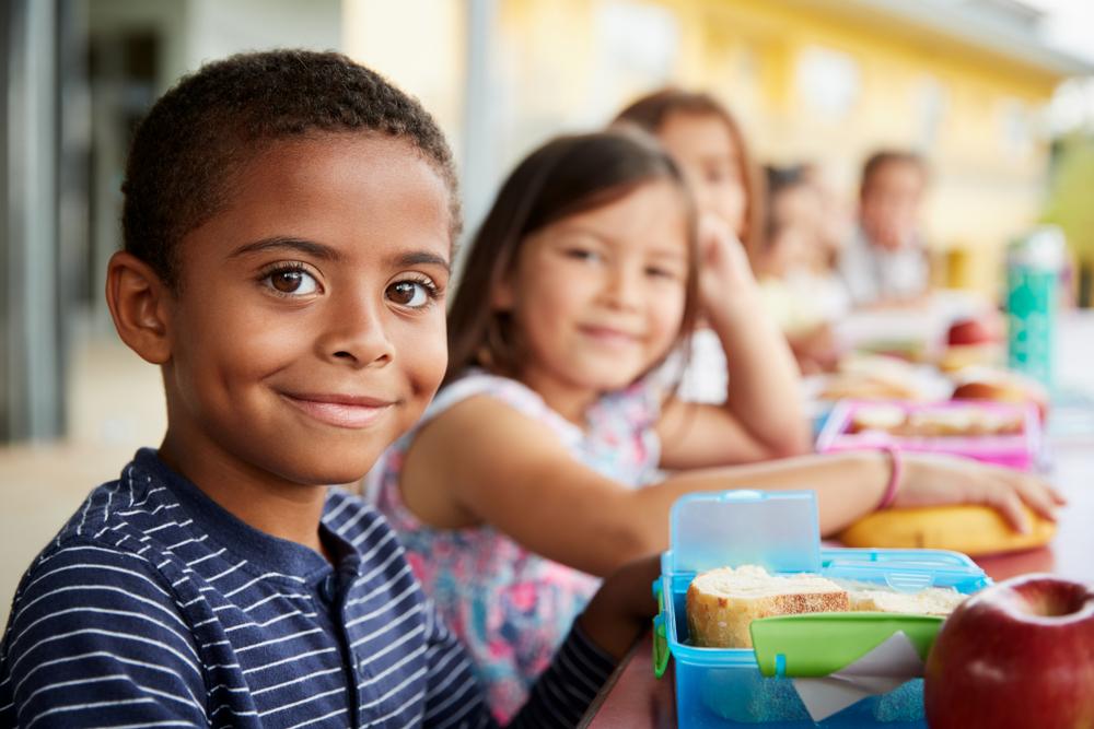 Happy youth boy and girl smiling in lunchroom