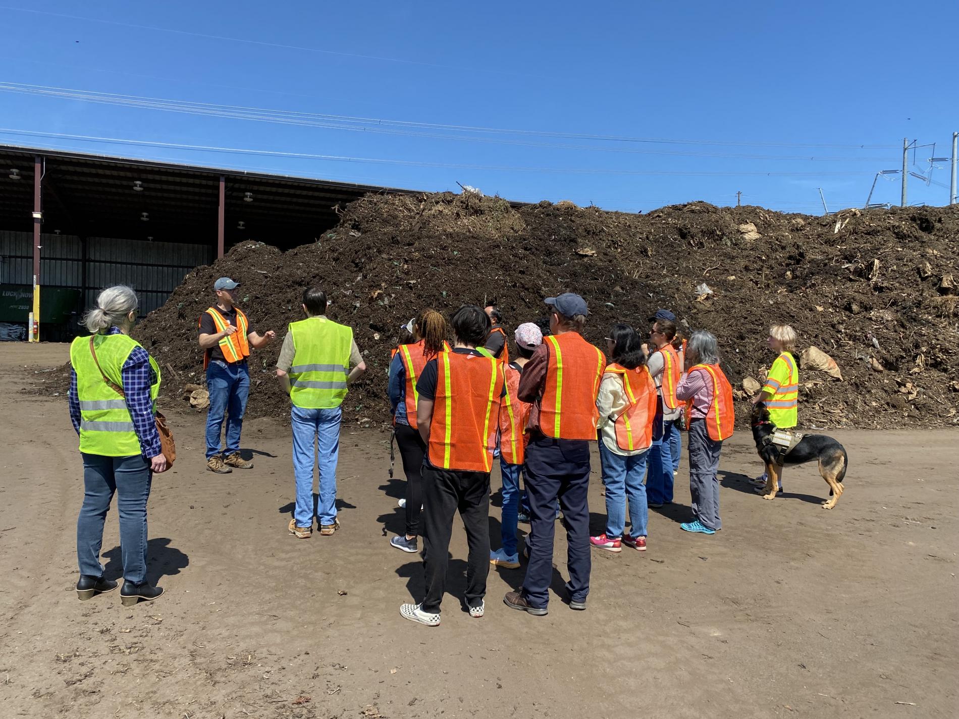 Compost facility tour - group of people with yellow/orange safety vest