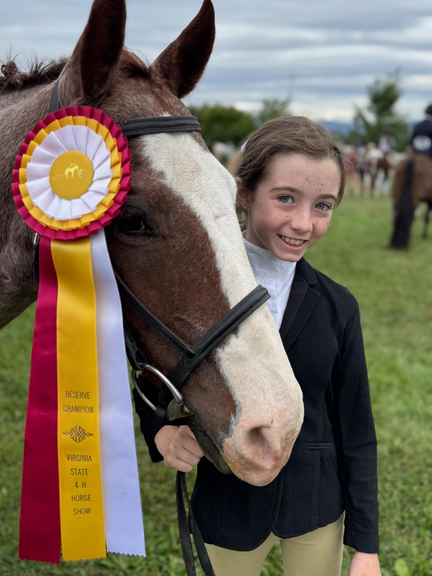 Prince William 4-H'er at the 2025 VA 4-H State Horse Show with her horse wearing an award ribbon,