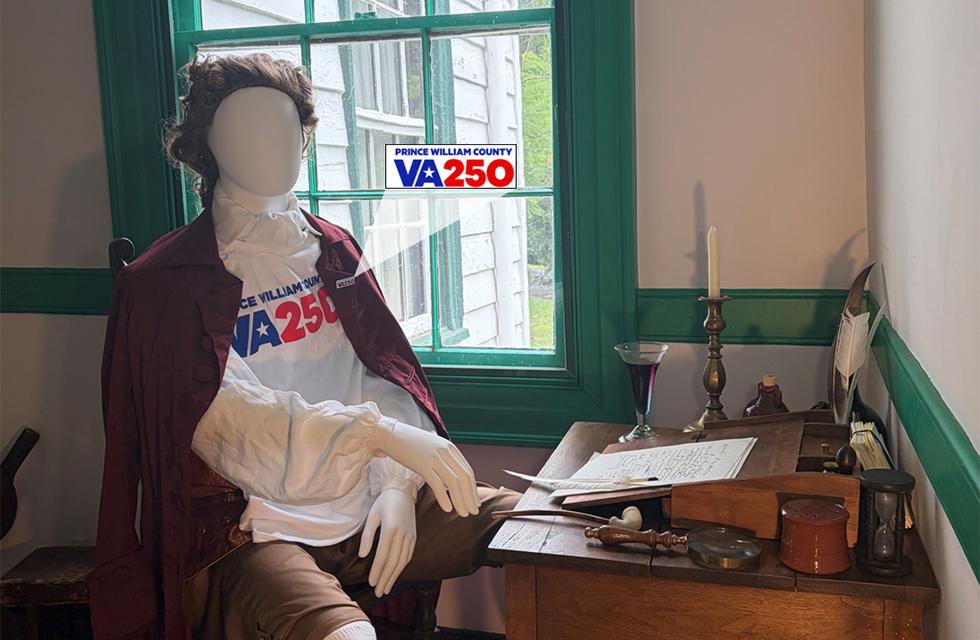 Character mannequin wearing VA250 tshirt at old fashioned 1700's desk