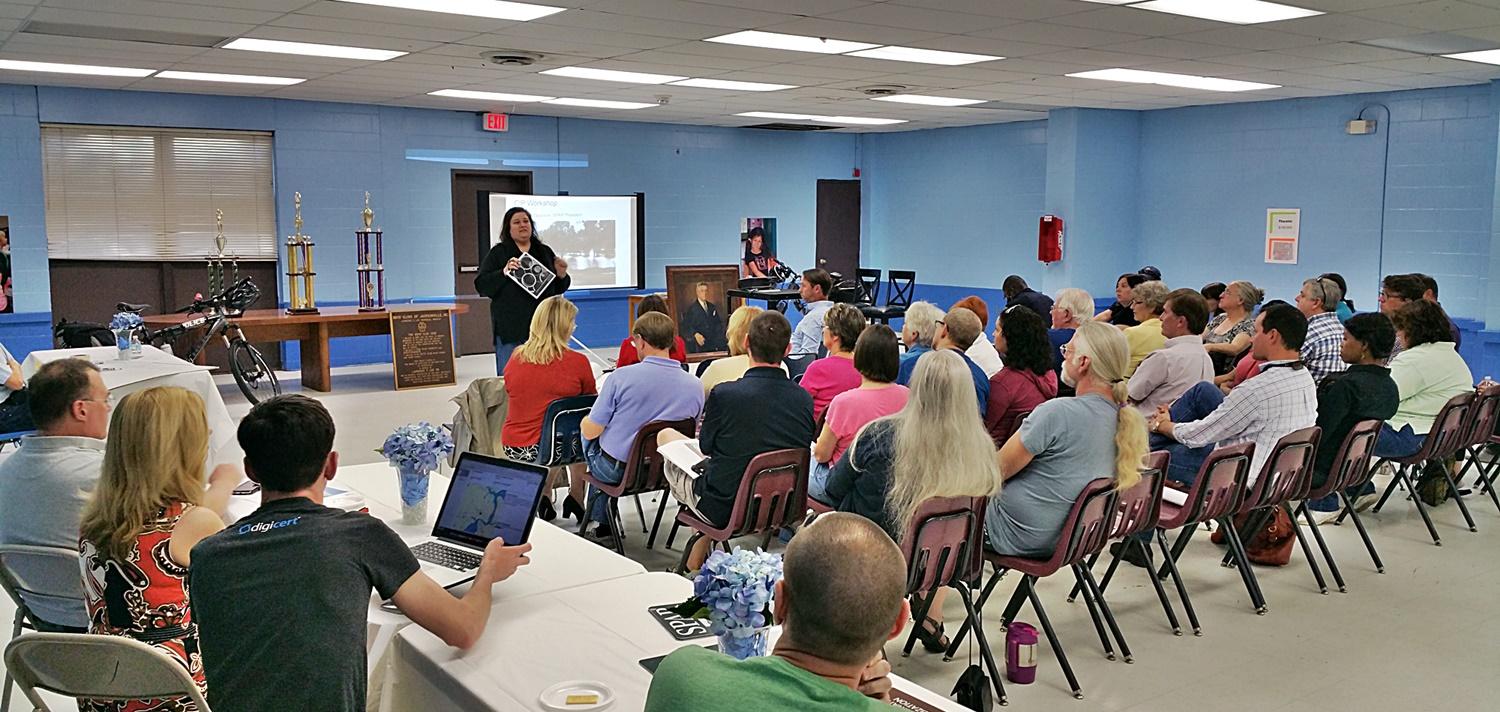 A community meeting taking place in a large room.