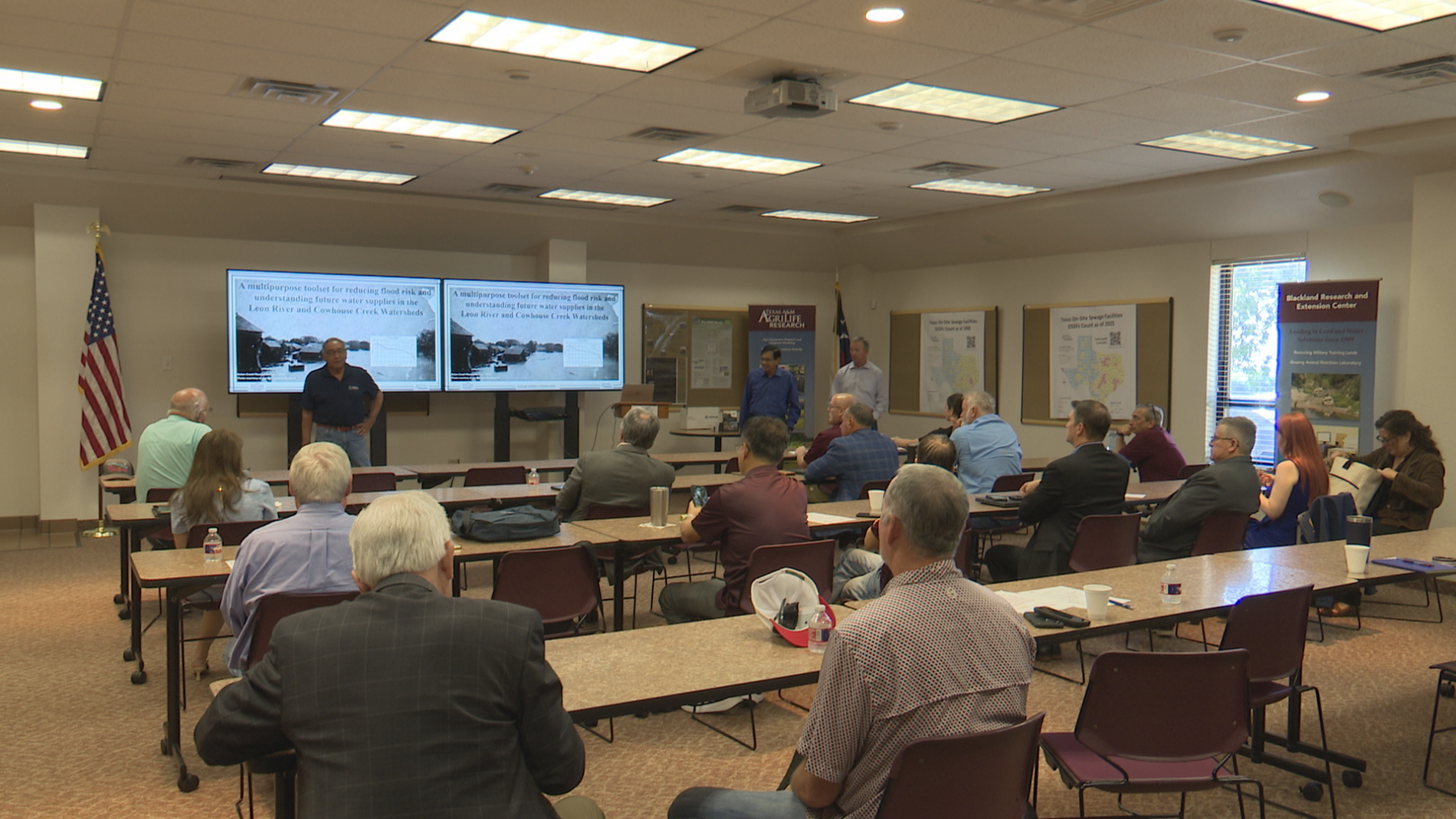 A presentation on flooding happening in a community meeting room.