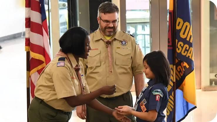 Scout receiving a badge after completing an activity.