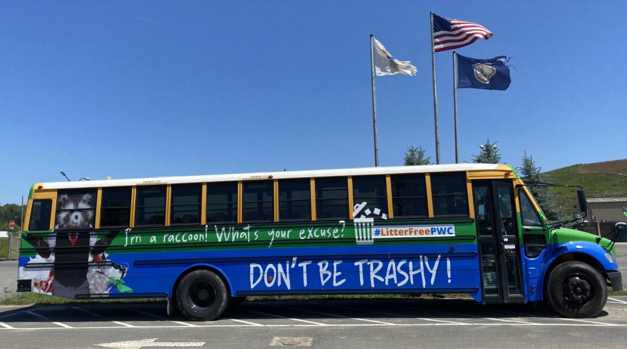 Landfill Tour Bus with Trashy the Raccoon mascot and text "DON'T BE TRASHY!"