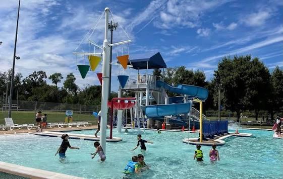 Children playing outside at a pool
